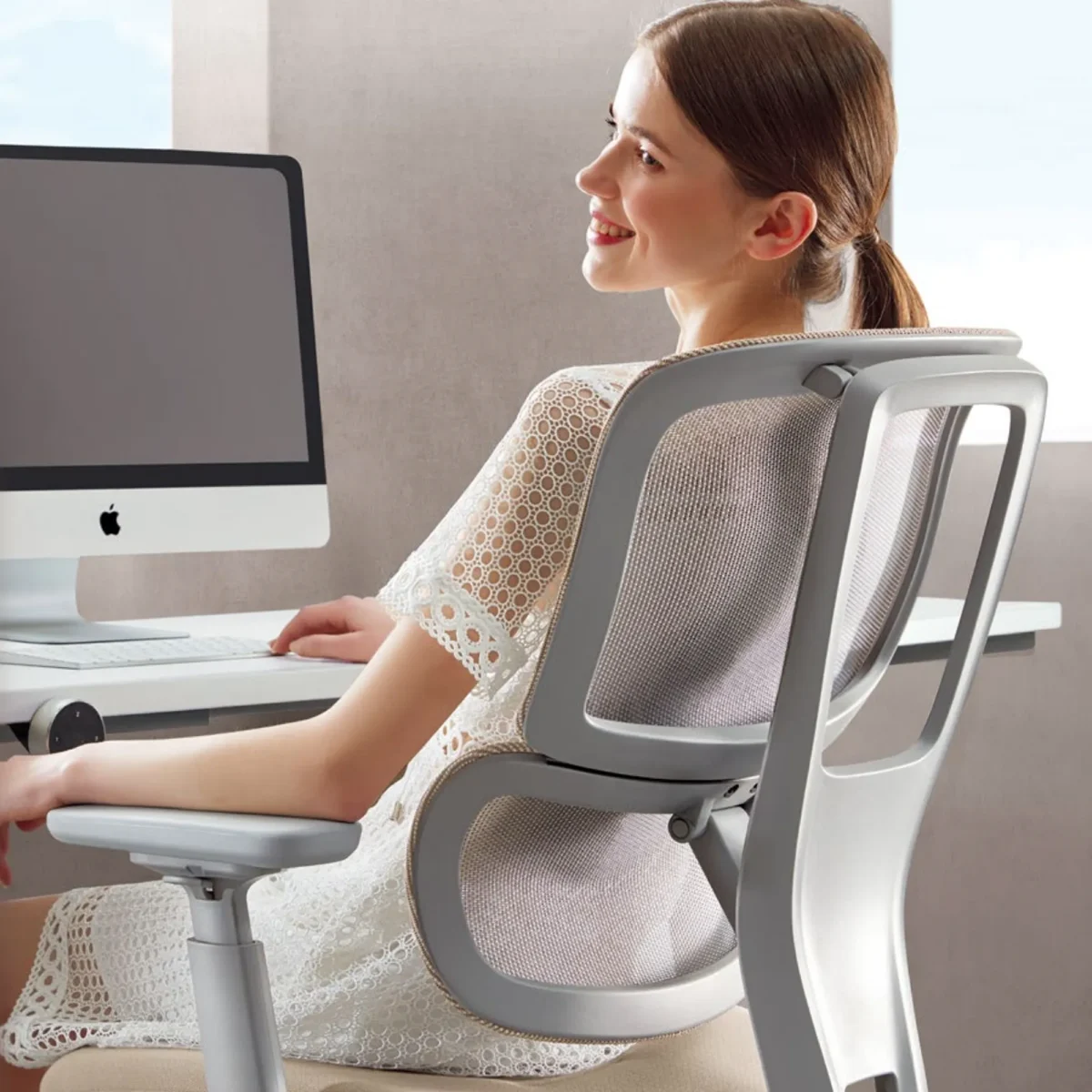 Officer Worker Sitting on a White H2 Ergonomic Medium Back Task Chair