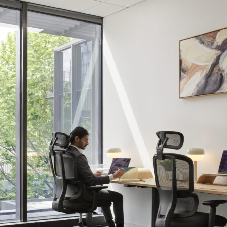 Staff Member Sitting in a Black H2 Ergonomic Medium Back Office Task Chair in at Waterman Moonee Ponds Coworking Centre
